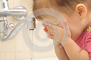 Little girl washing face