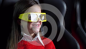 Little girl watching exciting movie at cinema with 3D glasses