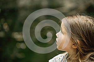 Little girl watching trees, skies and birds in awe