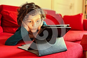 Little girl watching a video on a tablet.
