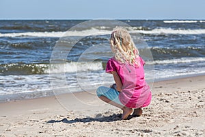 Little girl watching waves