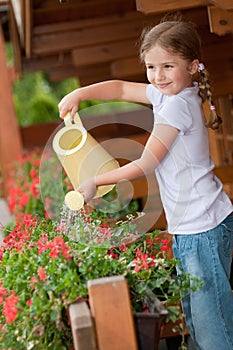 Little girl watering flowers