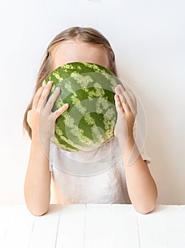 A little girl is a watermelon, croaks, laughs, humor, emotions, eat watermelon