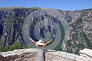 Little girl waves with a Greek flag on Vikos gorge Zagoria