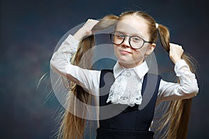 Little Girl Wear Glasses Look at Camera. Child Hold Hand on Ponytail