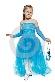 Little girl wearing blue ball dress in full length making curtsy