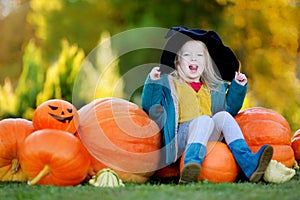 Little girl wearing halloween costume on a pumpkin patch