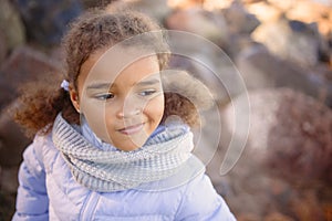 A little girl, wearing a hat and barefoot lends a glimpse of the sun. Journey with the concept of children