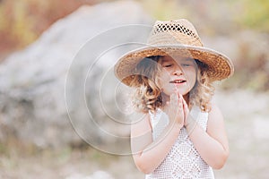 Little girl wearing a hat outdoors