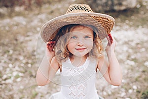Little girl wearing a hat outdoors