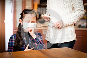 Little girl wearing mask and painfully coughing, mother worries