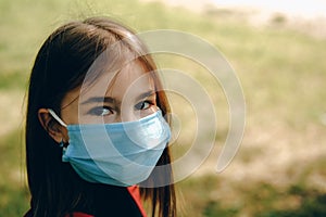 Little girl wearing protective mask.