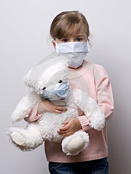 Little girl wearing a protective mask