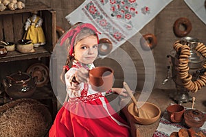 Adorable girl drinking tea from samovar
