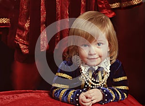 Little girl wearing renaissanse velvet dark blue dress