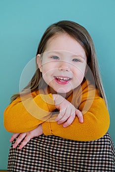 A little girl wearing a yellow shirt