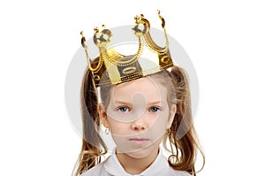 A little girl wears a crown
