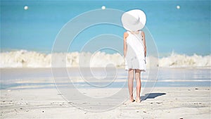 Little girl in white on the beach on caribbean vacation