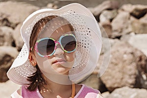 Little girl in a white beach hat