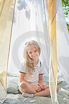 Little girl in white chiffon tent