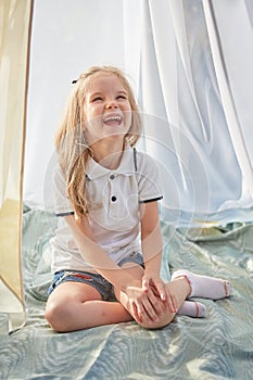 Little girl in white chiffon tent