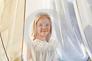 Little girl in white chiffon tent