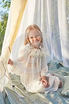 Little girl in white chiffon tent