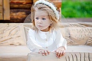 Little girl in a white dress in the village