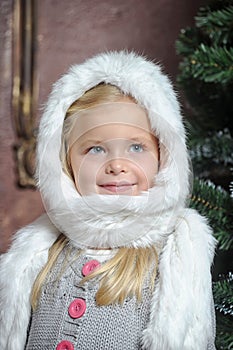 Little girl in white fur bonnet