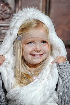 Little girl in white fur bonnet