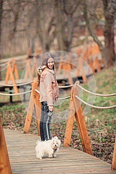 Little girl with a white puppy. A puppy in the hands of a girl