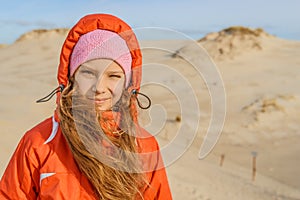 Little girl on white sand dunes of Leba