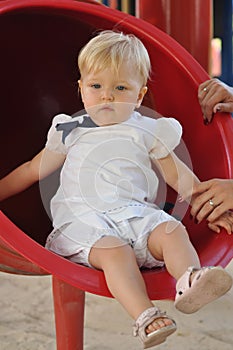 Little girl in white suit in park