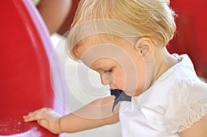 Little girl in white suit in park