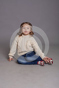 Little girl in white sweater and jeans