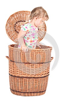 Little girl in wicker box