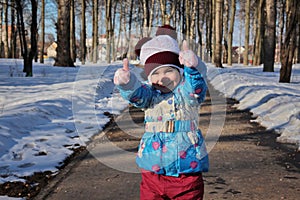 Little girl in winter sunny day