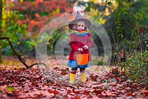 Little girl in witch costume at Halloween