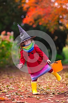 Little girl in witch costume at Halloween