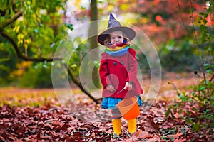 Little girl in witch costume at Halloween