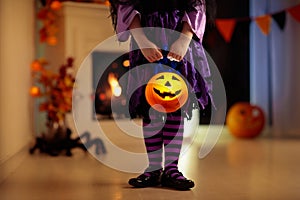 Kids in witch costume on Halloween trick or treat photo