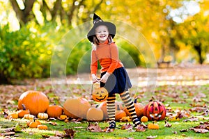 Little girl in witch costume on Halloween trick or treat