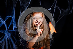 Little girl in witch Halloween costume having fun . Trick or treat