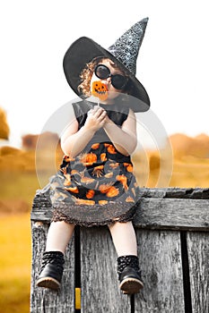 Little girl witch sitting on a roof photo