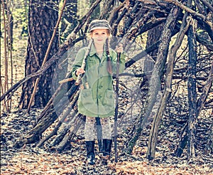 Little girl in the wood near the hut