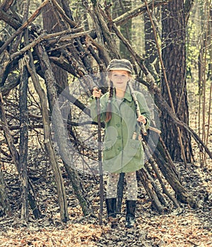 Little girl in the wood near hut