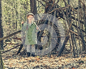 Little girl in the wood near hut