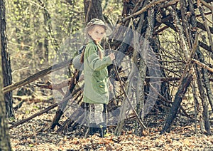 Little girl in the wood near hut