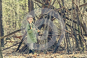 Little girl in the wood near hut