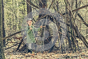 Little girl in the wood near hut